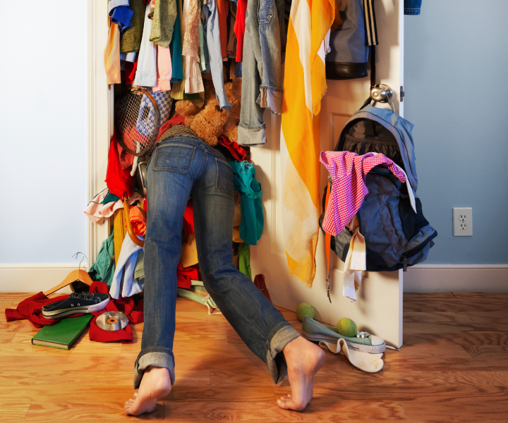 Person digging through crowded closet - the American Dream